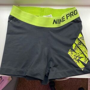 Black and green Nike pros